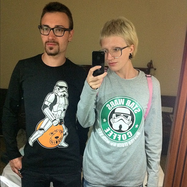man and woman take po in mirror with star wars tee - shirt
