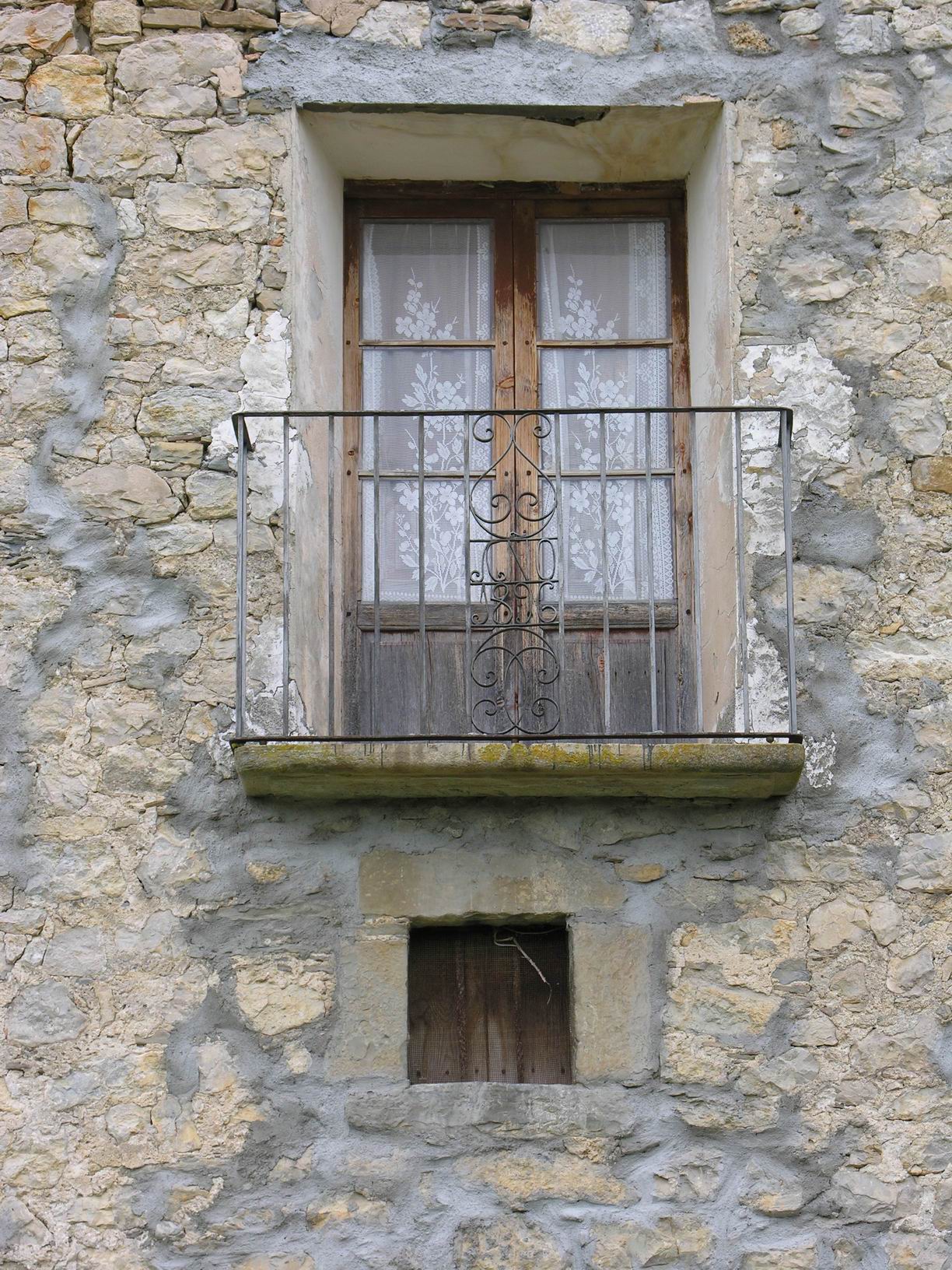 the open window is attached to a stone building