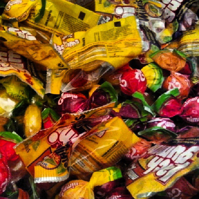 candy is piled high with colorful ribbons