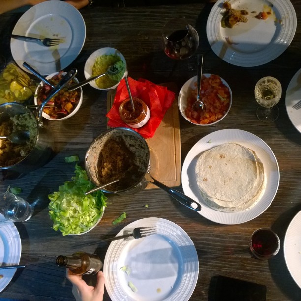 a large table is filled with plates, glasses and condiments