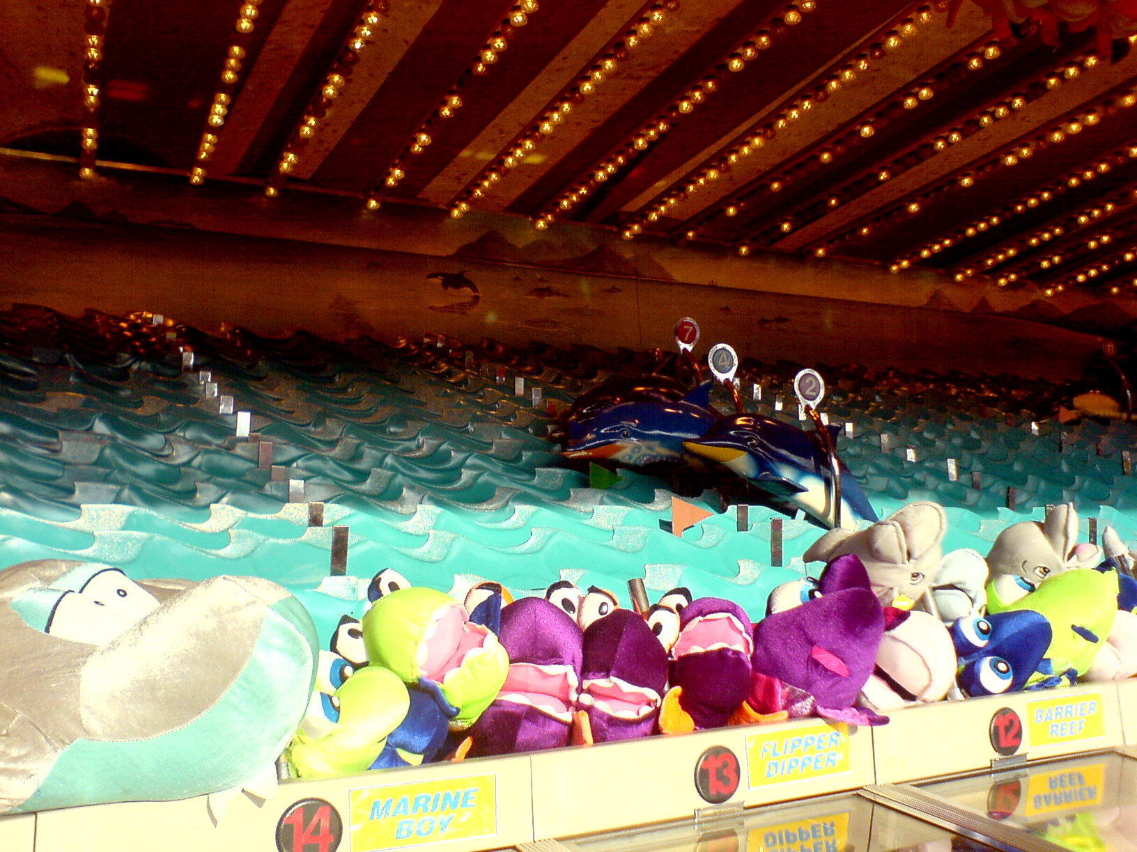 an assortment of stuffed animals in the water at a fair