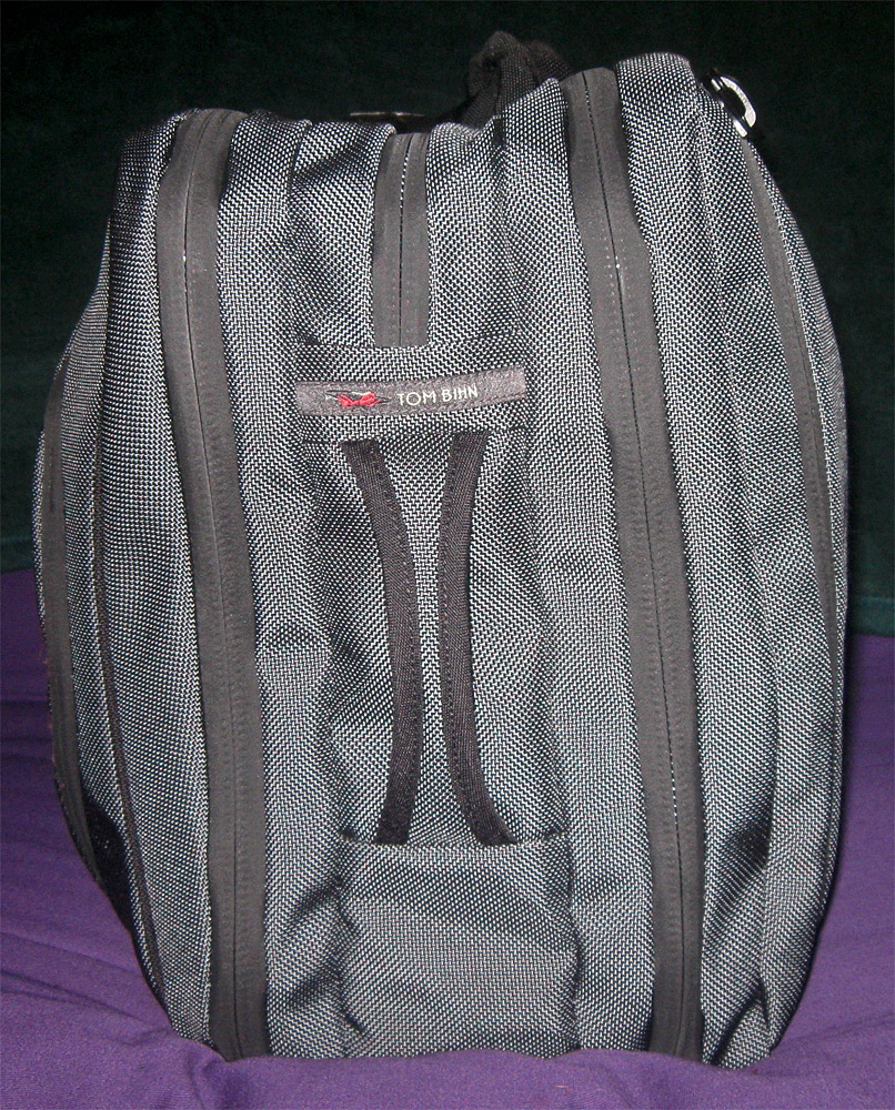 a gray bag sits on a purple pillow