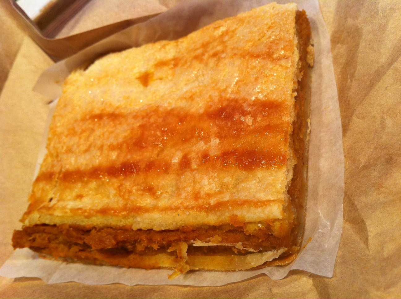 sandwich on piece of wax paper sitting on a table