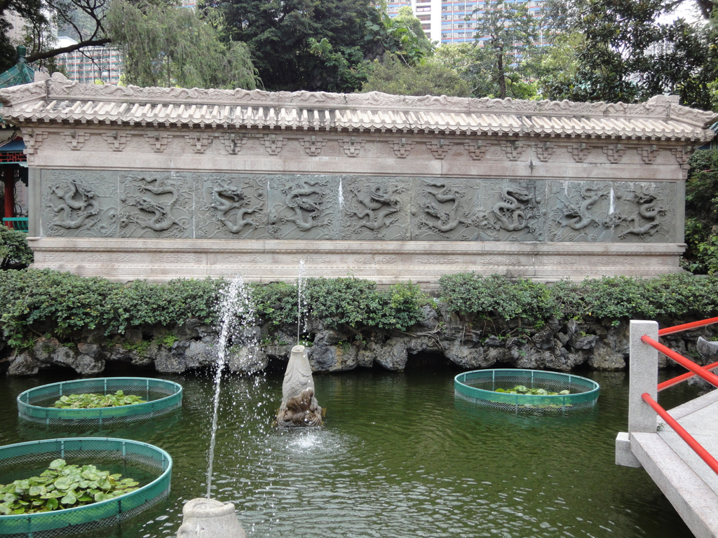 a fountain surrounded by many green water bowls