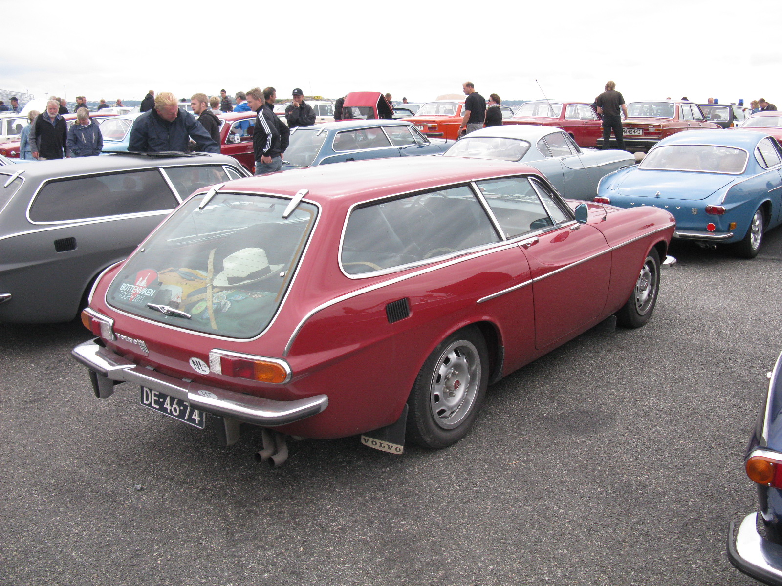 a red and black car parked in a parking lot