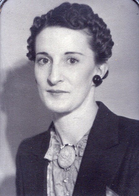 an old po of a woman wearing a coat and earrings