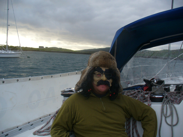 the man is wearing a silly mask and driving a boat