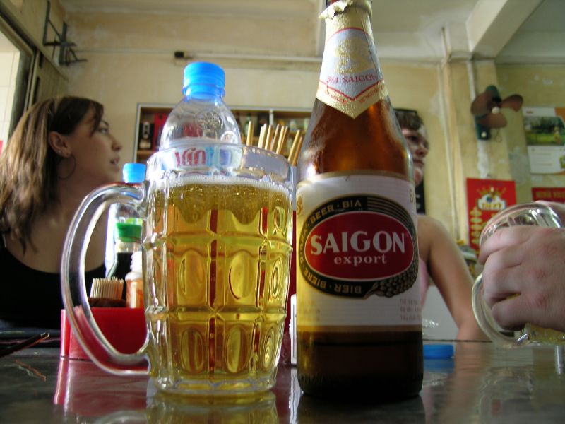 a couple people drinking beer at a table