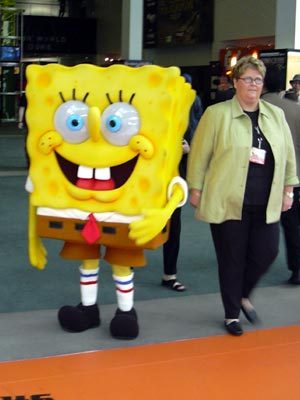 a large cartoon sponge bob standing in the middle of a group