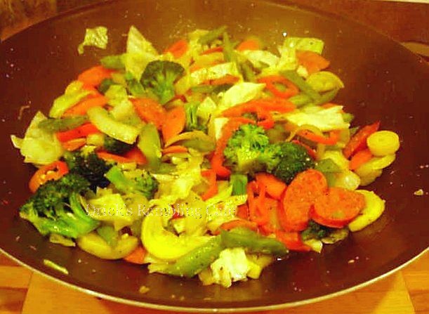 the vegetables in the pan are mixed with broccoli and carrots