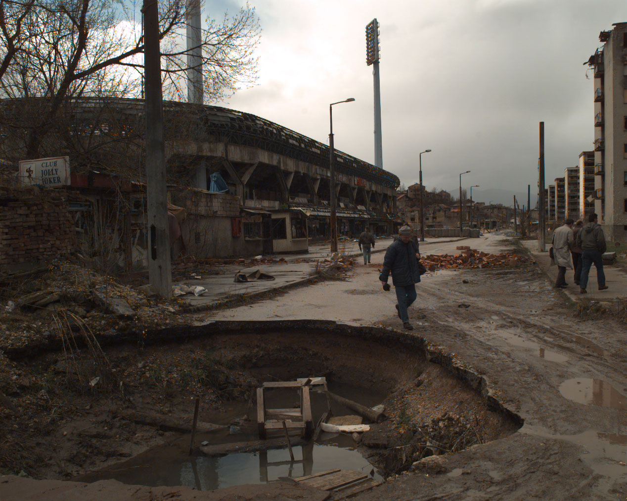 a man walking through a very large building that has been demolished