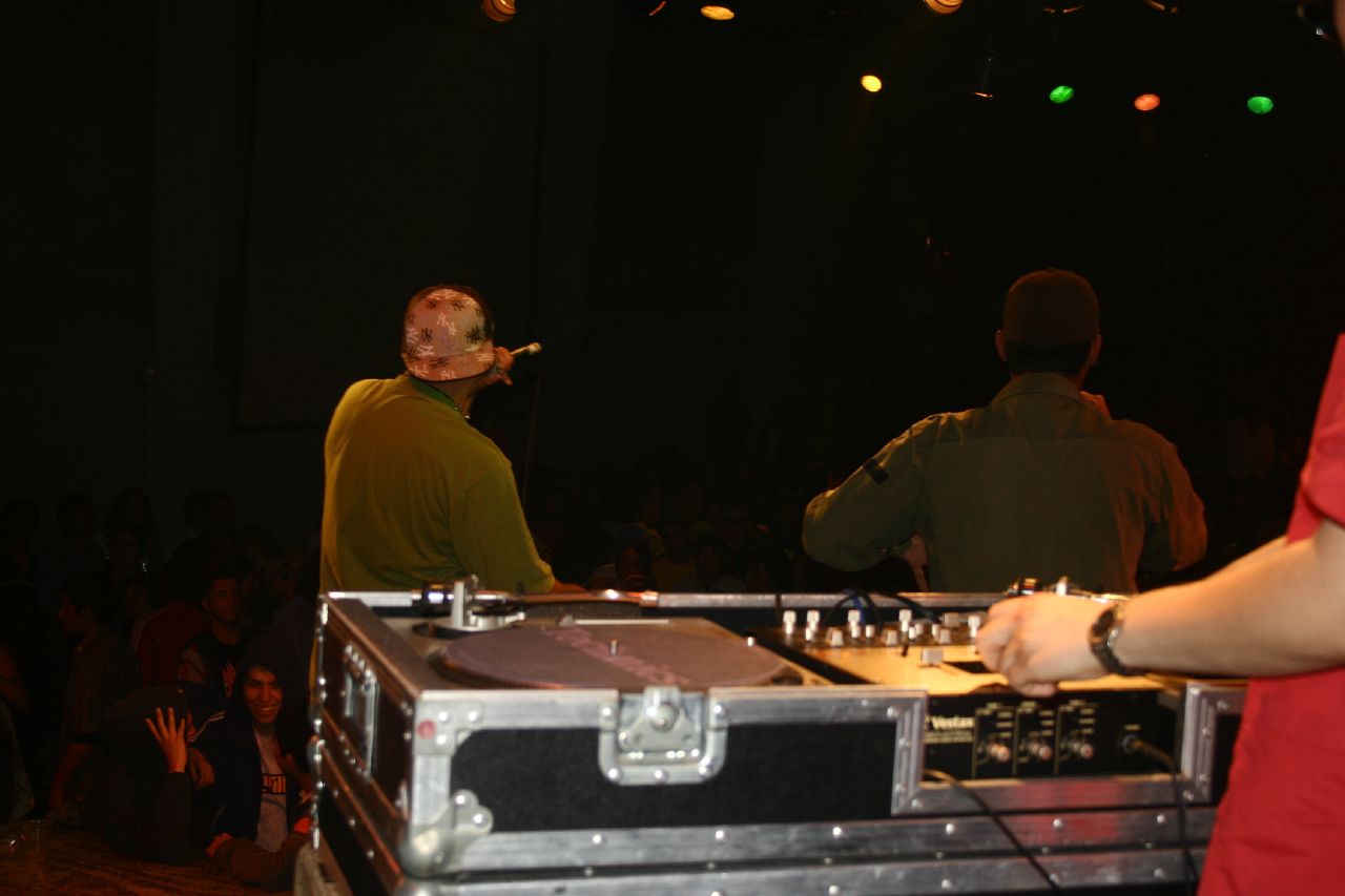 a dj mixes up a track on his turntables