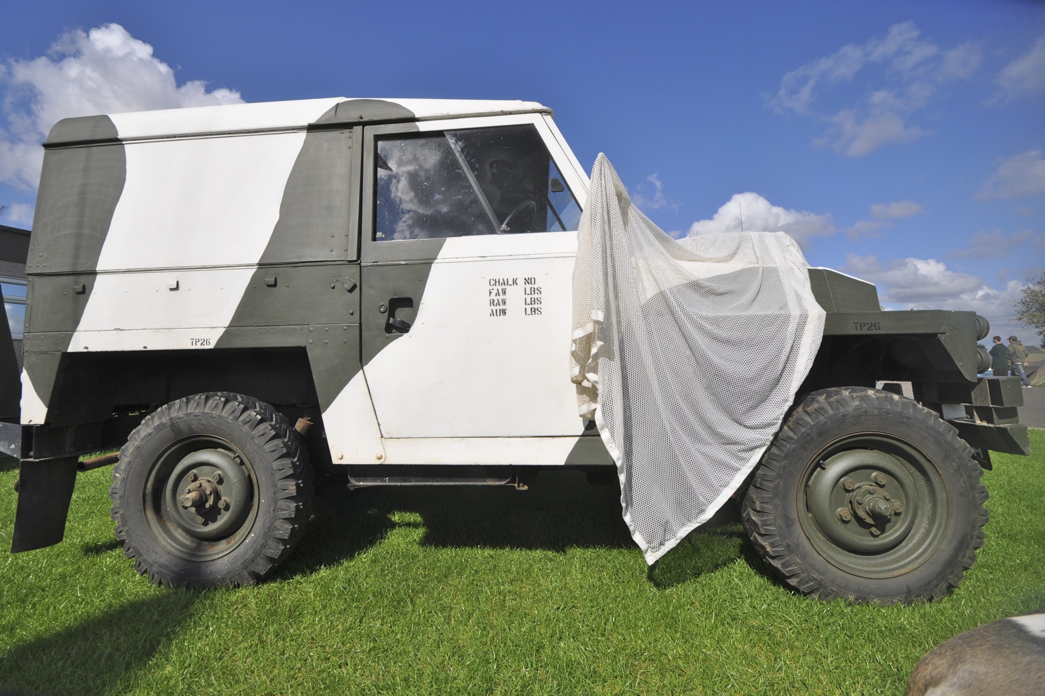 an army armored truck with a sheet on the side