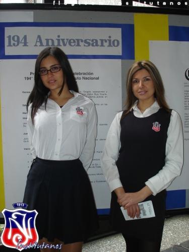 two women stand in front of an info poster