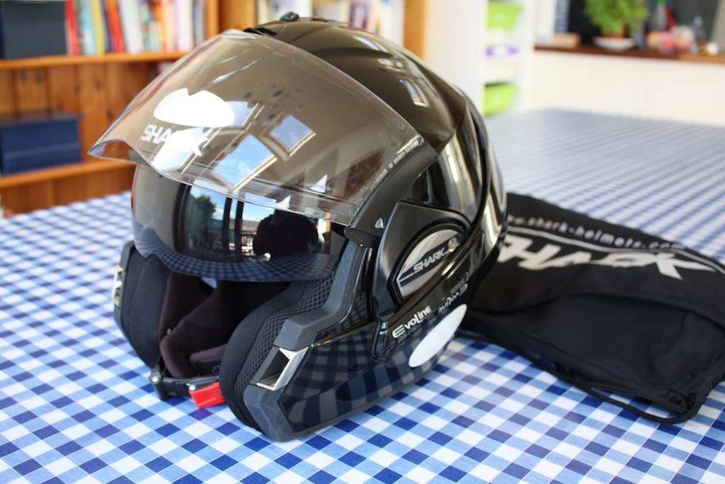 a helmet and a pair of gloves laying on a table