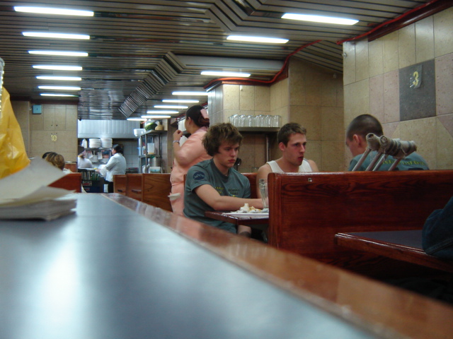 the people are all enjoying their meals while sitting at tables