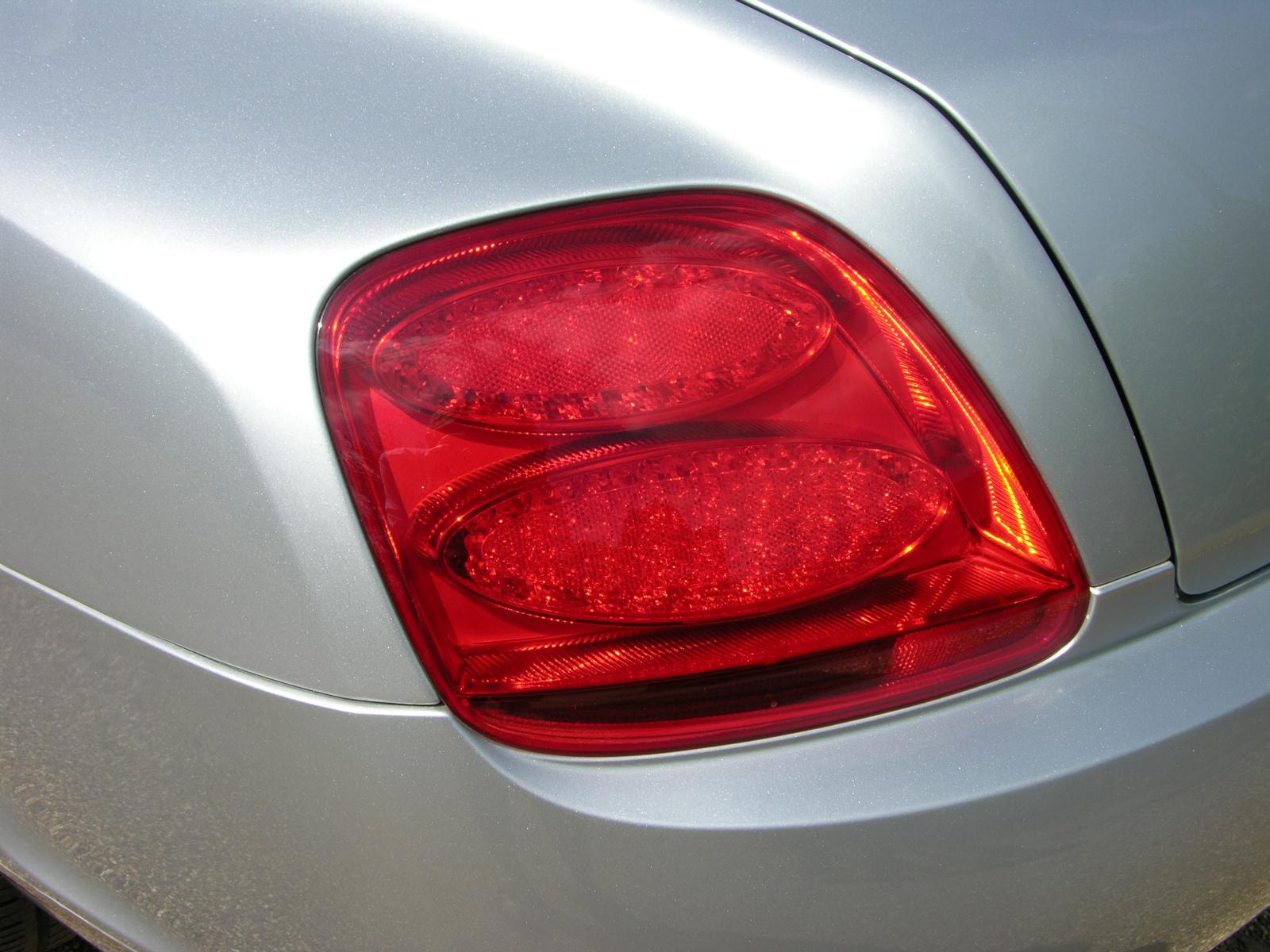 there are two lights on the back of this silver car