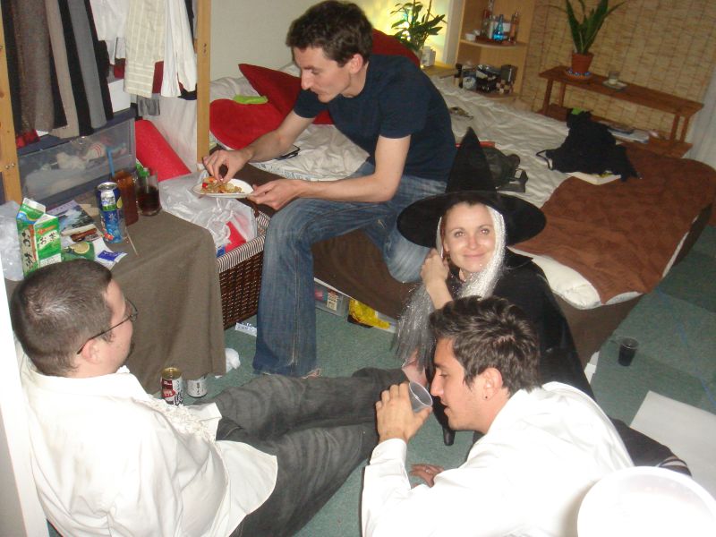 a group of young men eating pizza in a living room