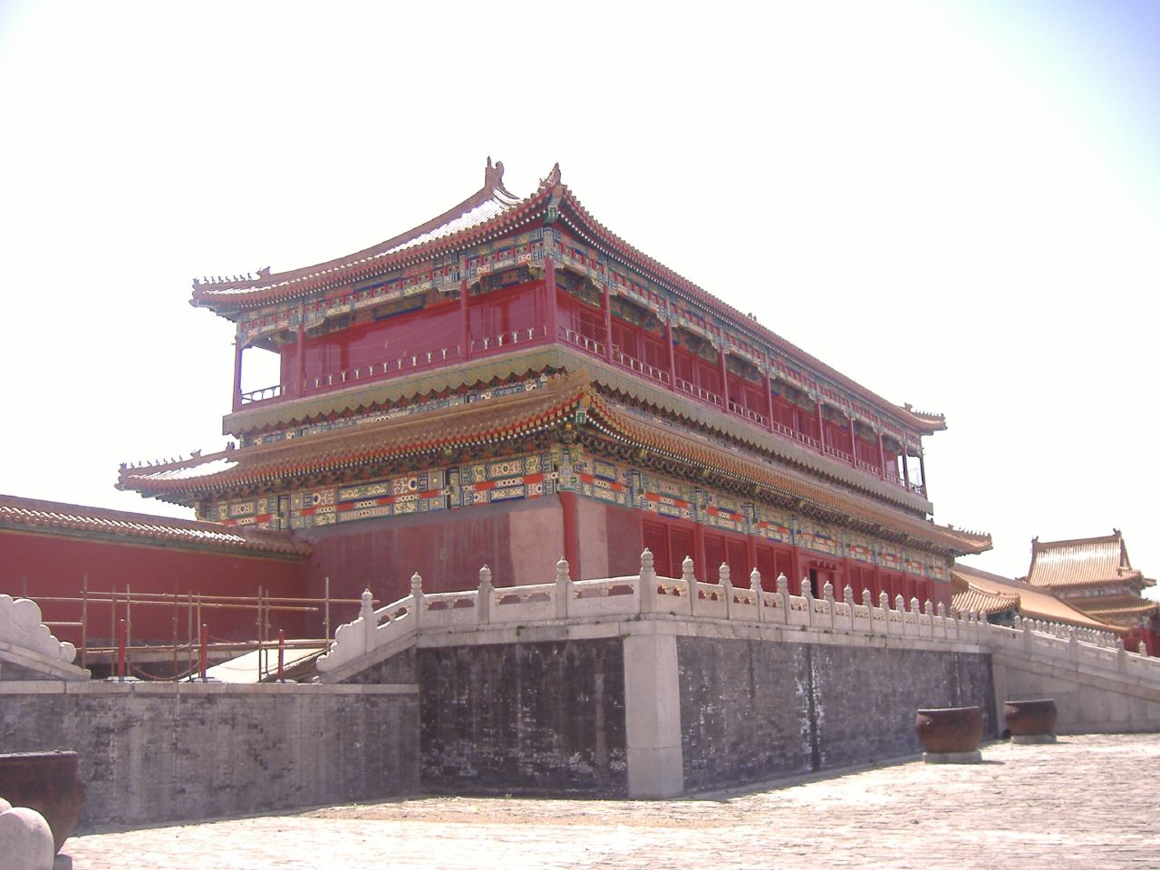 a chinese style structure is painted red, yellow and white