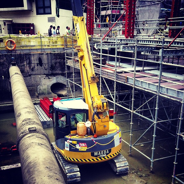 a large crane sits near a construction area
