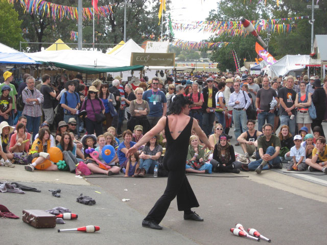 two men are performing a street dance in front of a crowd of people