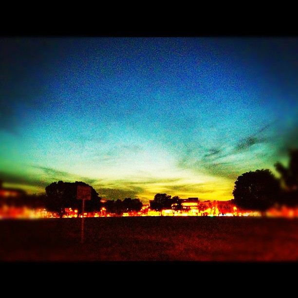 a colorful sunset seen over an open area