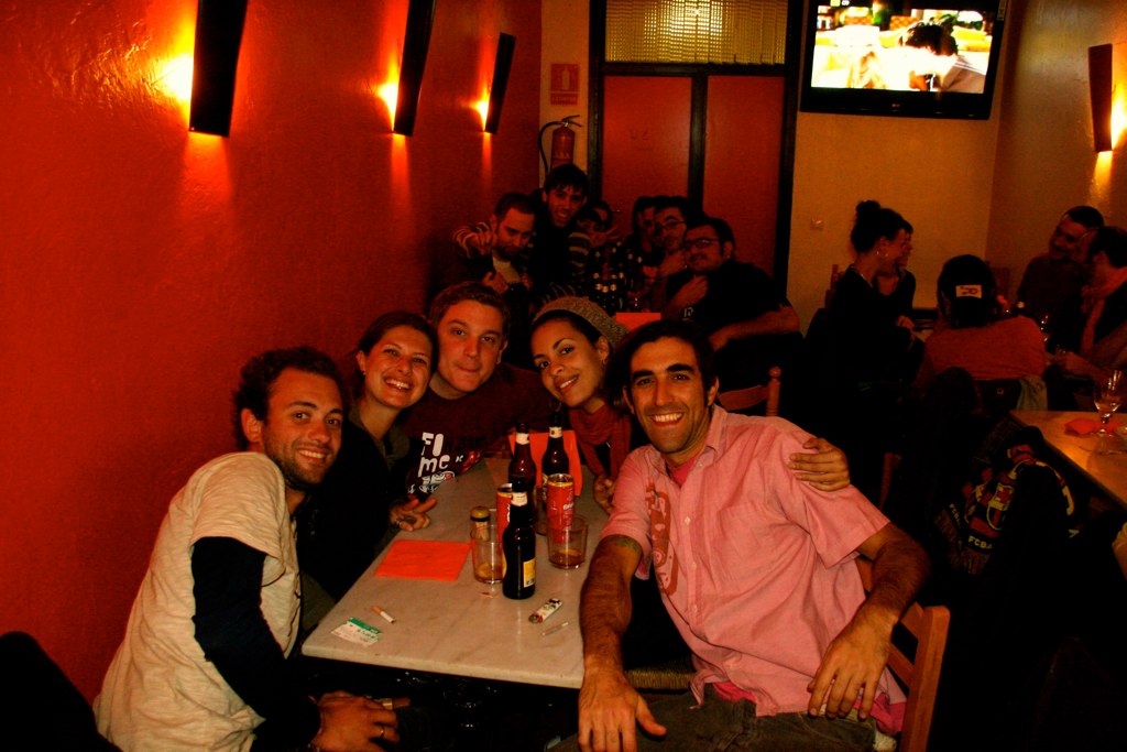 a group of people sitting at a table and smiling