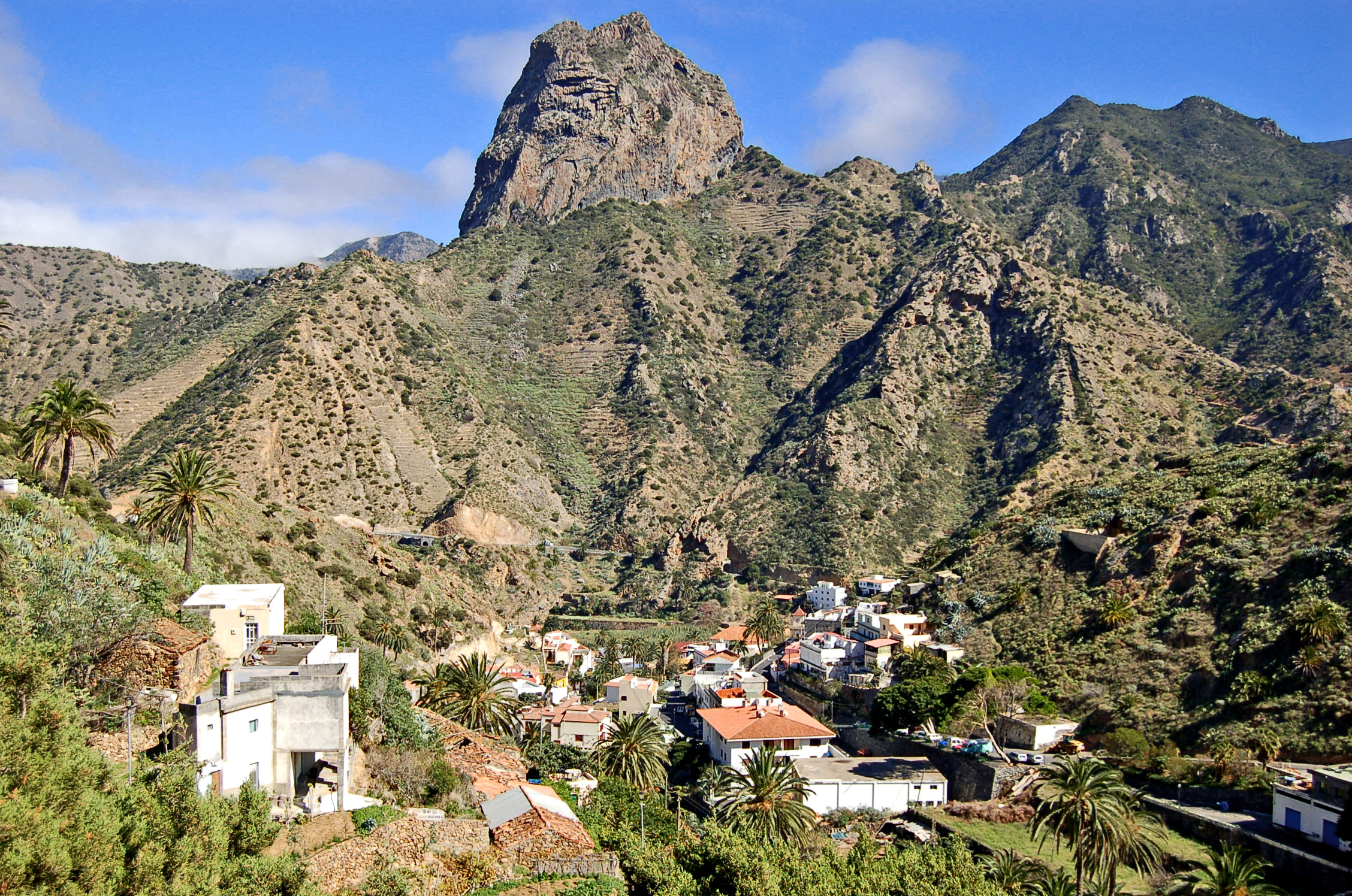 a village perched on a hill with green vegetation