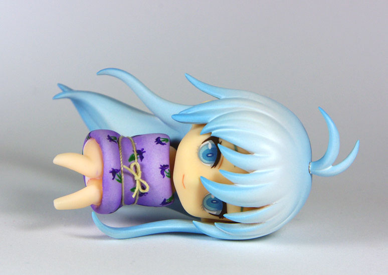 a small figurine has a purple shirt and purple hair