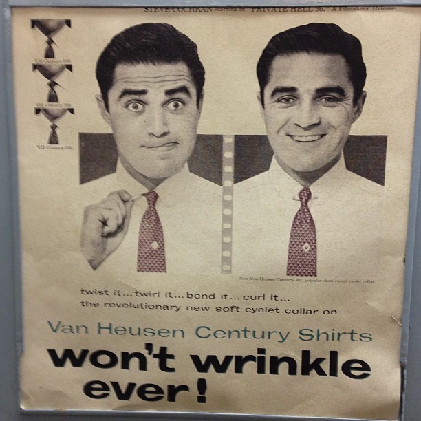 an ad on a bathroom stall for two men with ties