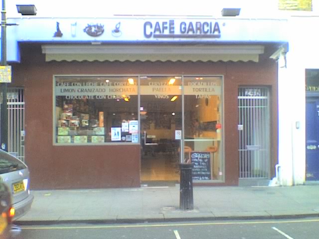 the shopfront of a cafe on a street