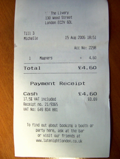 a receipt sitting on top of a wooden table