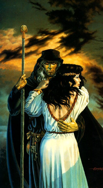 a man and woman stand with a spear by the ocean