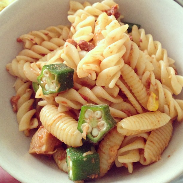 a bowl filled with food and vegetables sitting on a table