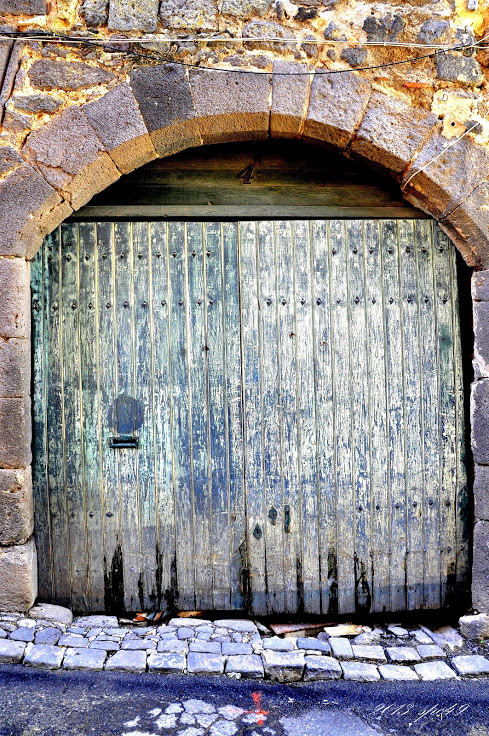 the door of a small building with stone bricks