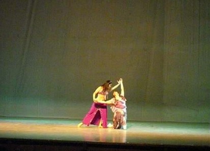 two women doing soing on a stage