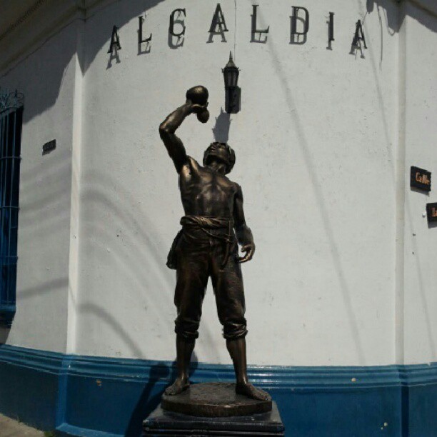 the statue is of a man with an object in his hand
