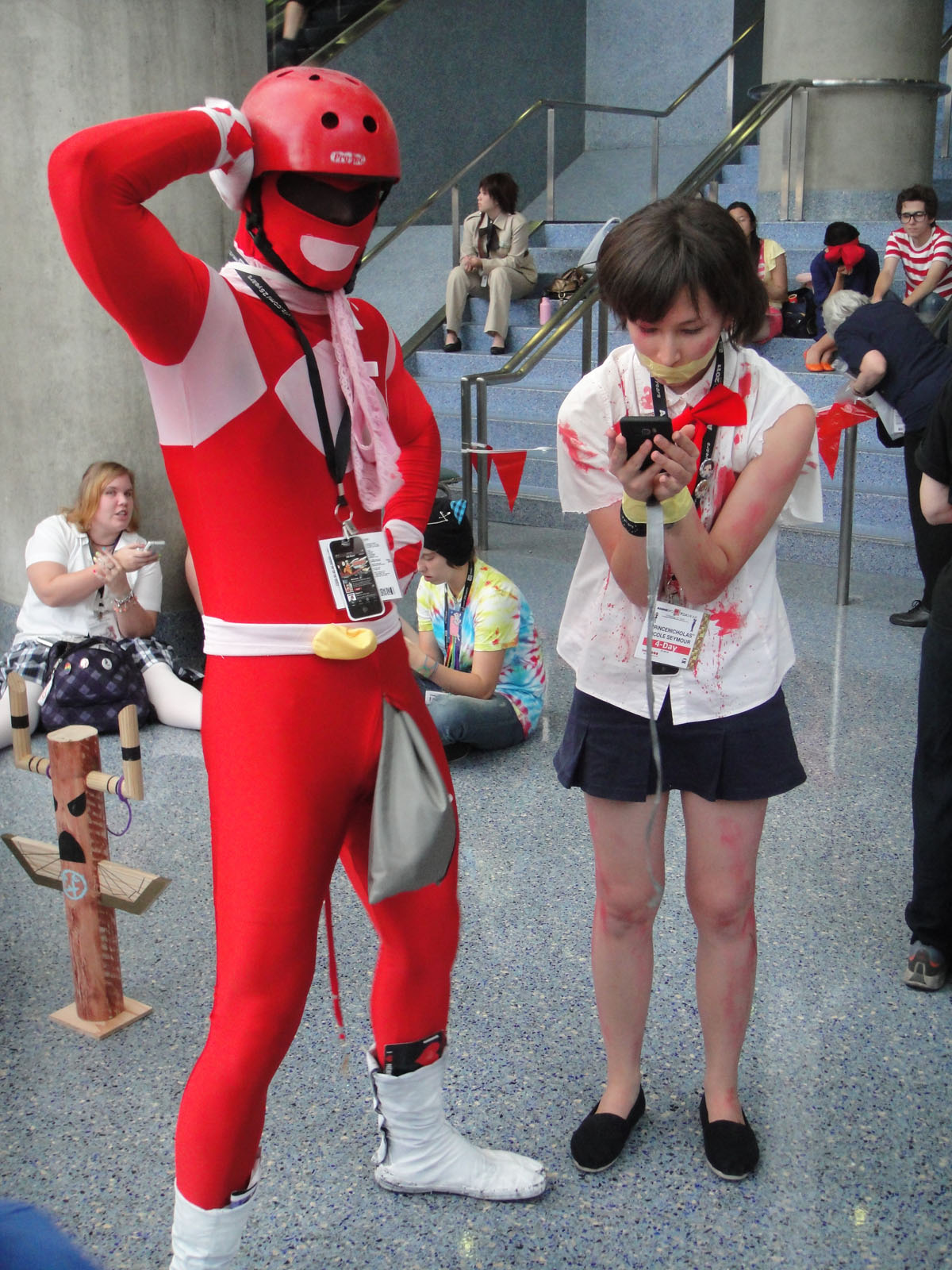 people in costumes taking pictures of a person dressed as a spider man