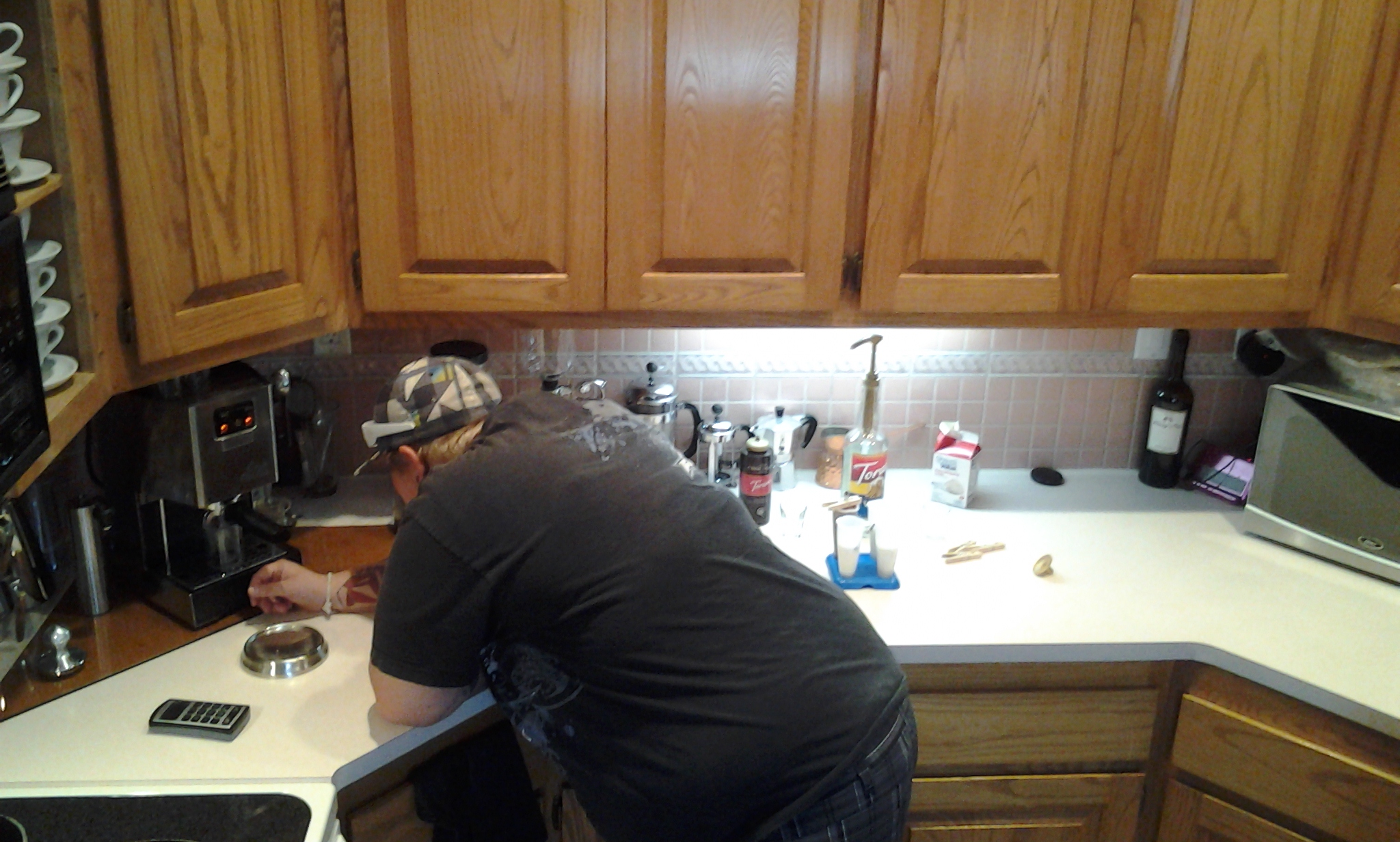 a person preparing food in a kitchen on a counter