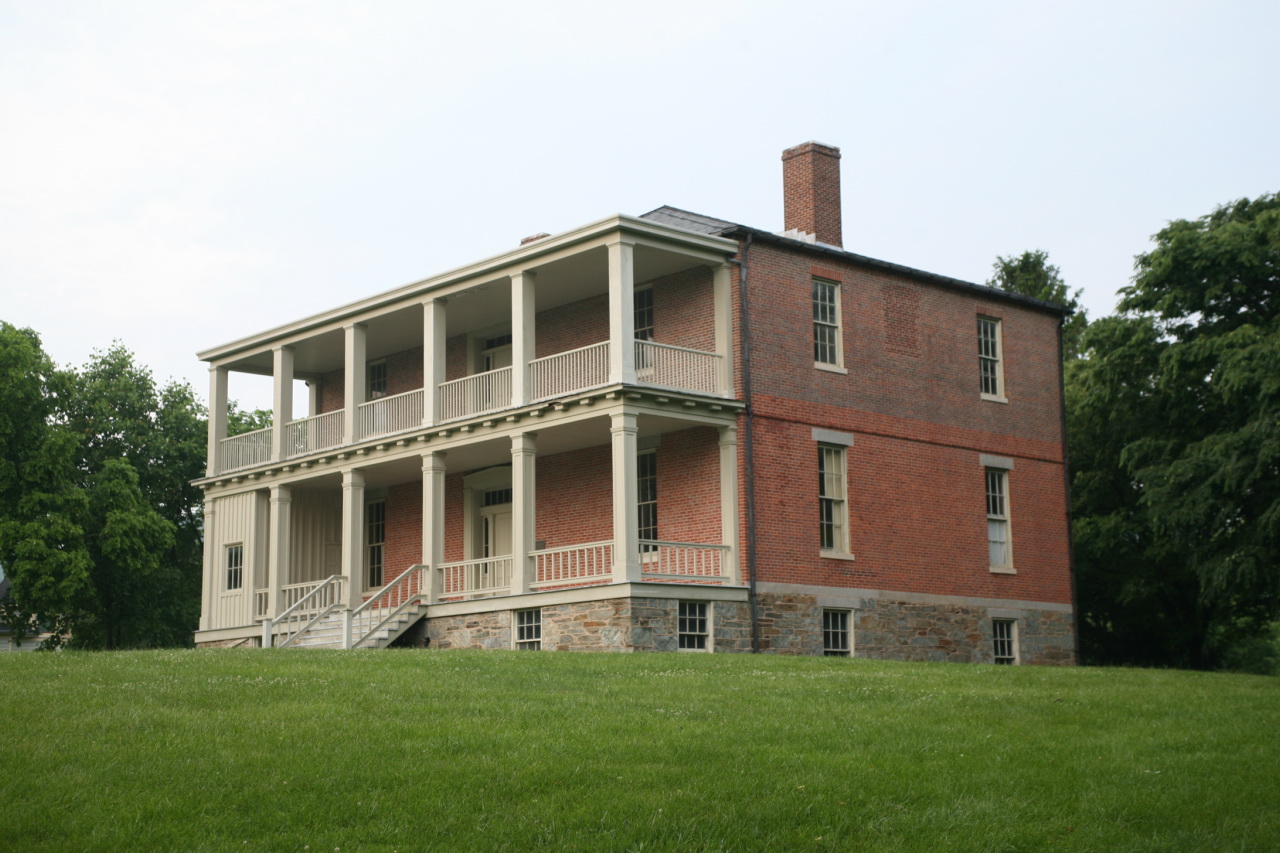 a brick building with balconys in a grassy area