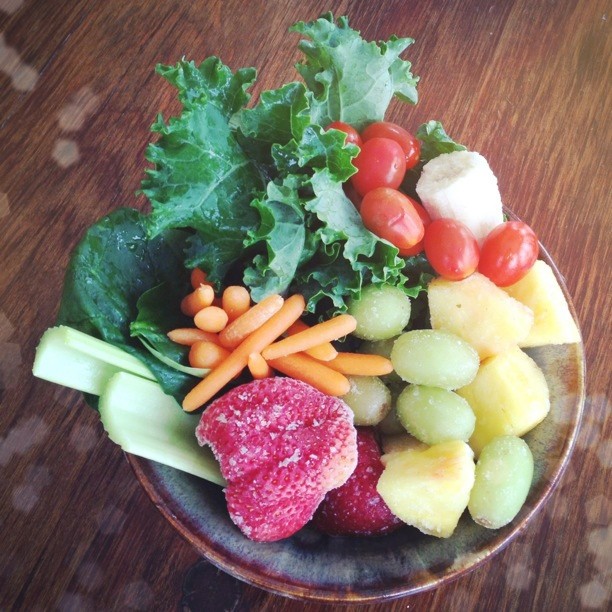 a small bowl with many different fruits and vegetables in it
