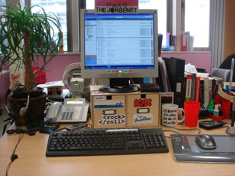 a desk with computer monitor and keyboard