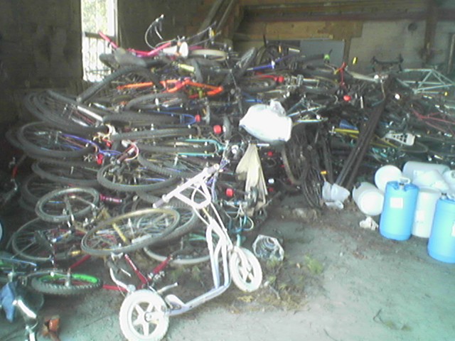 several bikes in a garage and one being pulled down