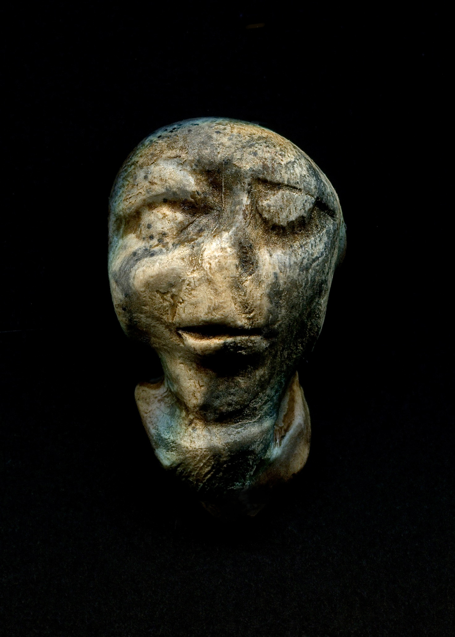the head of an ancient sculpture with a weird expression