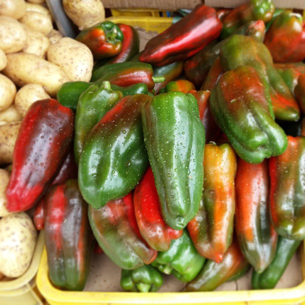 a close up of a basket of peppers in vegetables