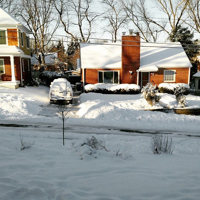 the house is almost completely covered in snow