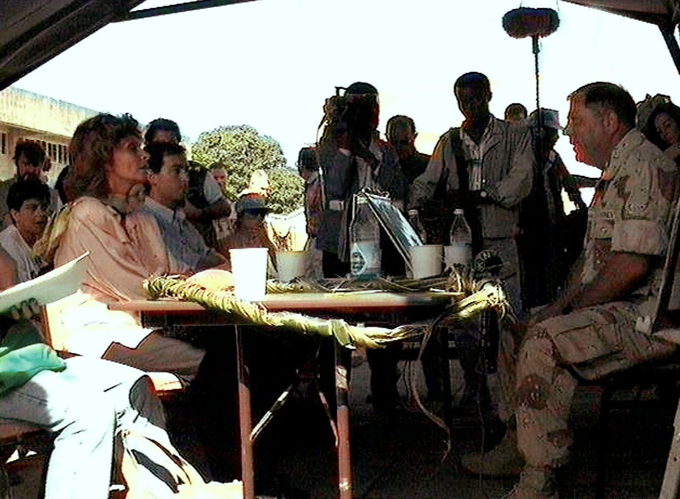 a group of people sitting around a table next to each other