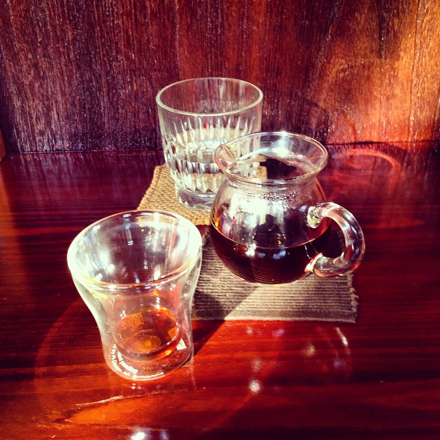 two glasses sitting next to each other with water in them