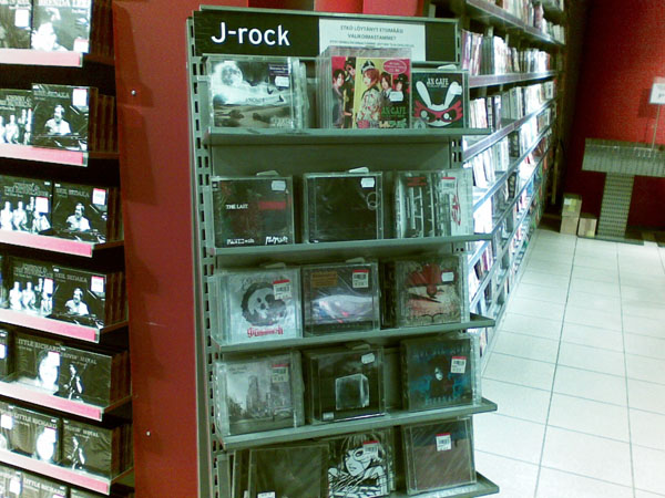 a record player stands in front of an open rack