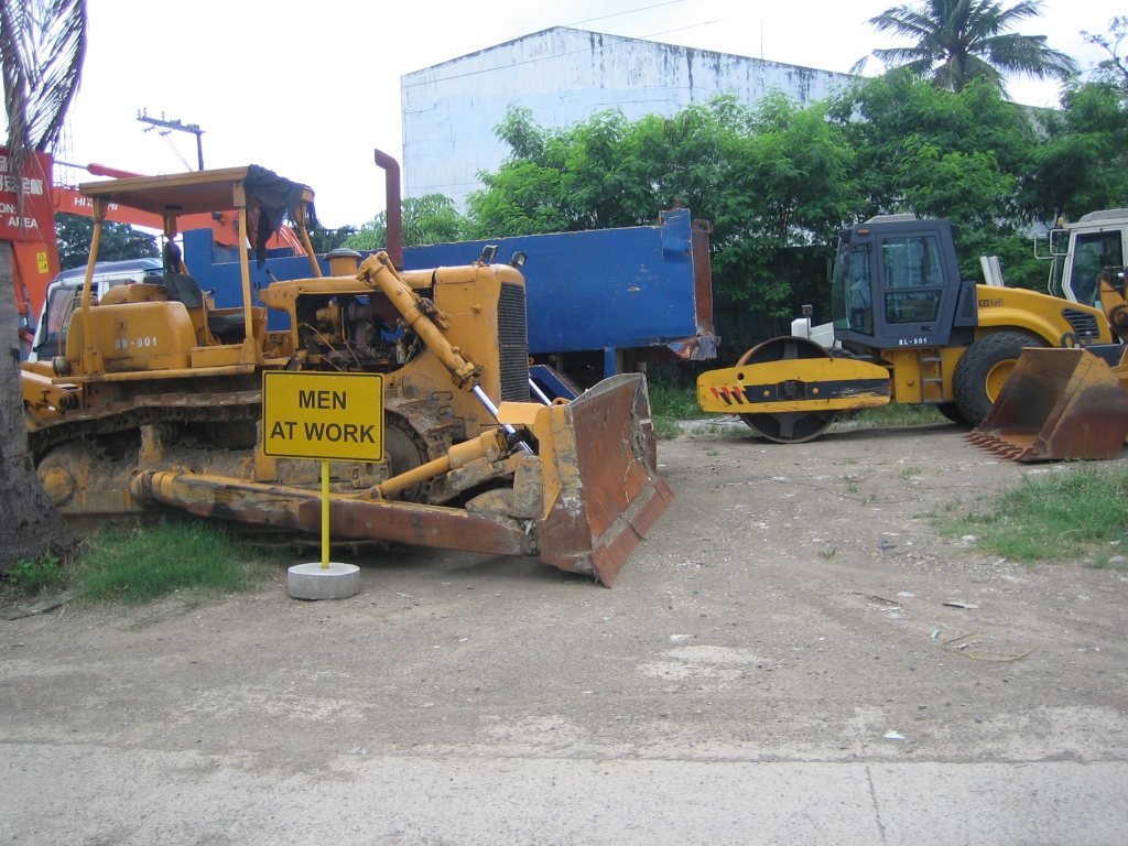 bulldozer and tractor parts are in a yard